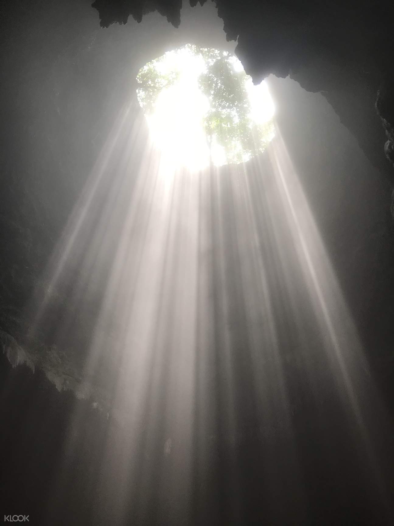 catch the sunlight bursting through the roof of the jomblang