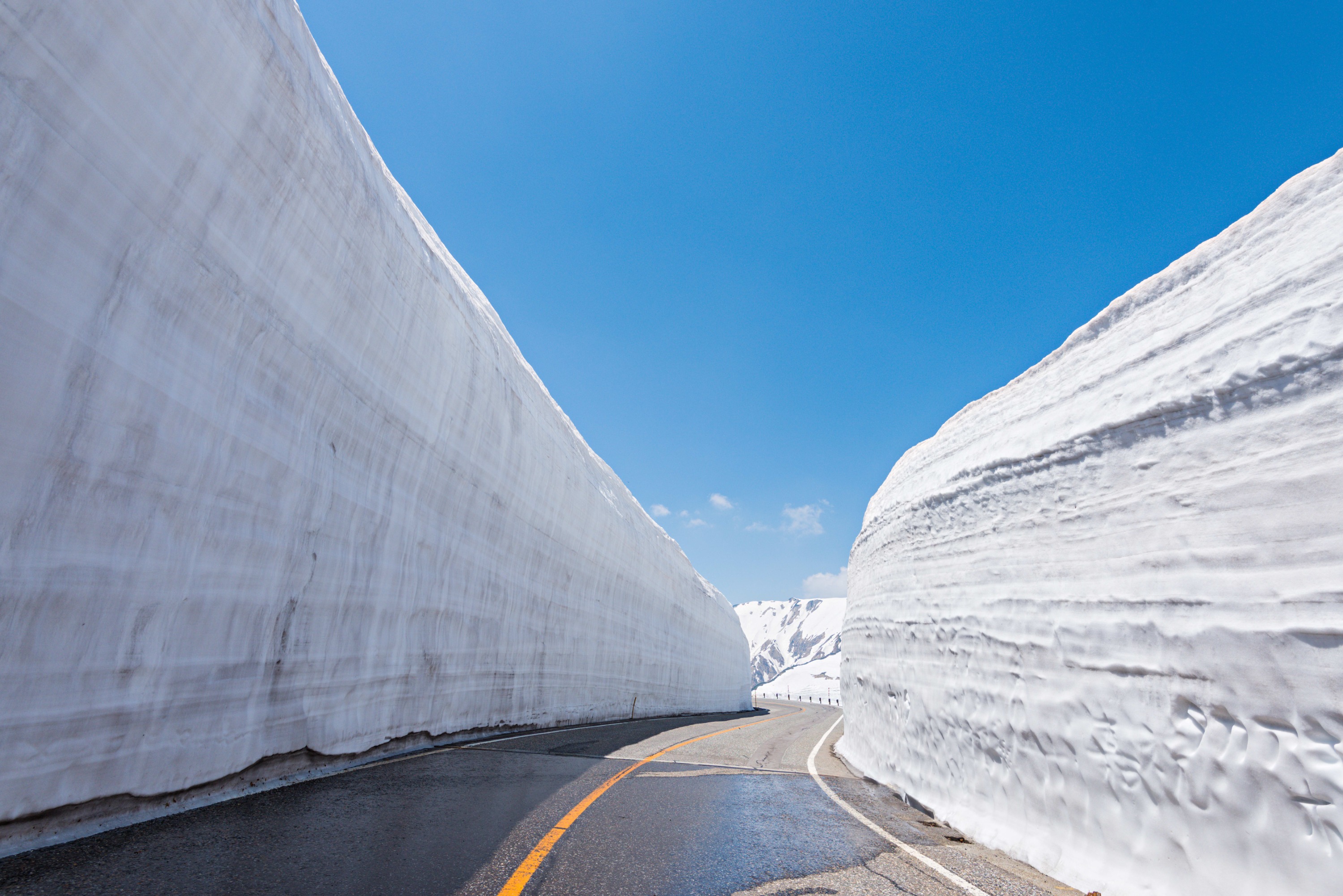 A breathtaking, crystal-clear view of Mikurigaike Pond at Mount Tateyama, part of the Tateyama Kurobe Alpine Route, in winter
