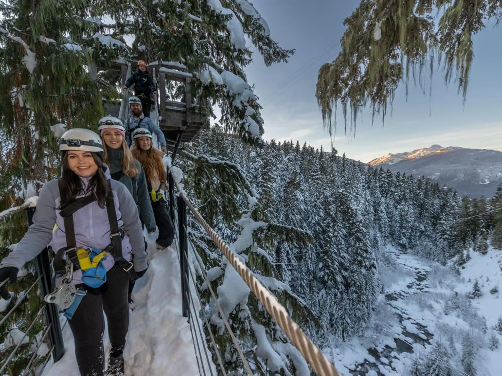 Ziplining in winter offers a breathtaking view of snow-dusted treetops and mountain peaks