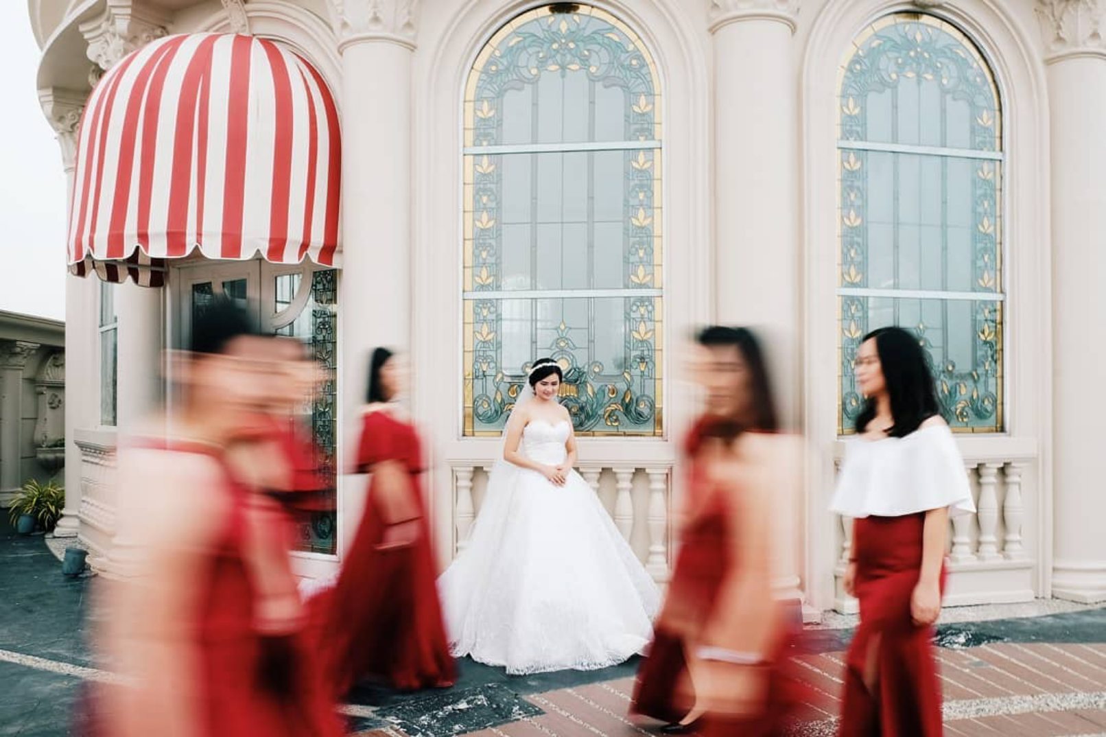 Woman in bridal dress in front of store