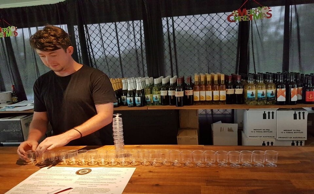 a man preparing glasses of wine