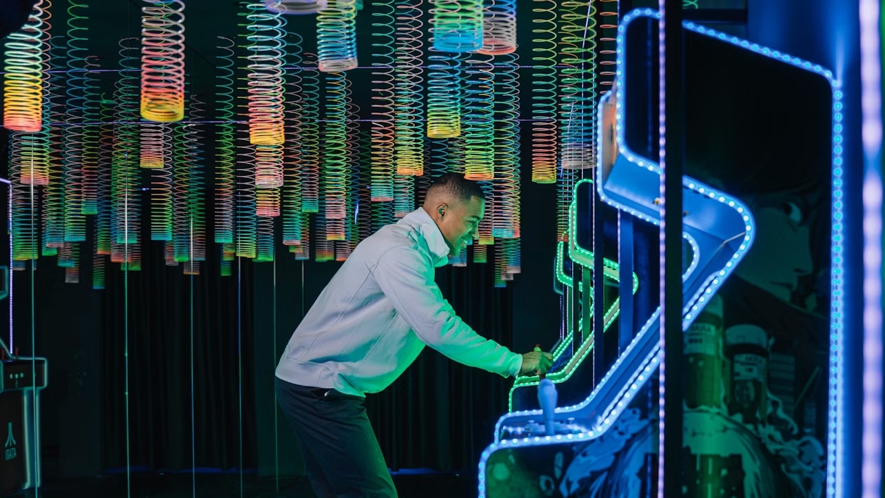 Enjoy a colorful, thrilling adventure in the retro-inspired Motherboard Arcade installation
