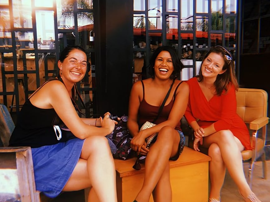 Friends laugh and snap cheerful photos together, making memories in Tijuana’s welcoming atmosphere