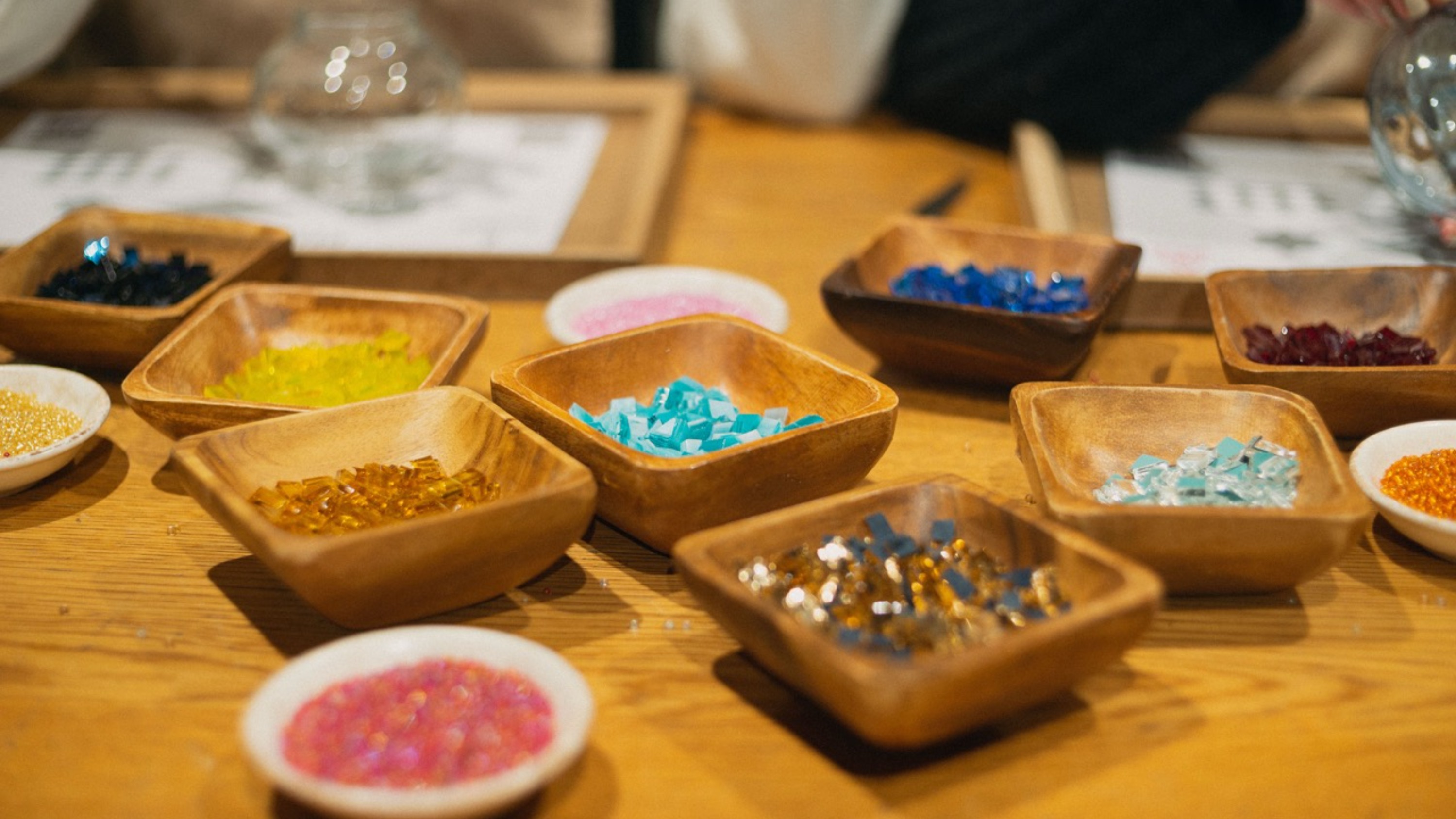 A participant smiles proudly while crafting her mosaic lamp in a vibrant Mosaic Lamp Workshop in Istanbul