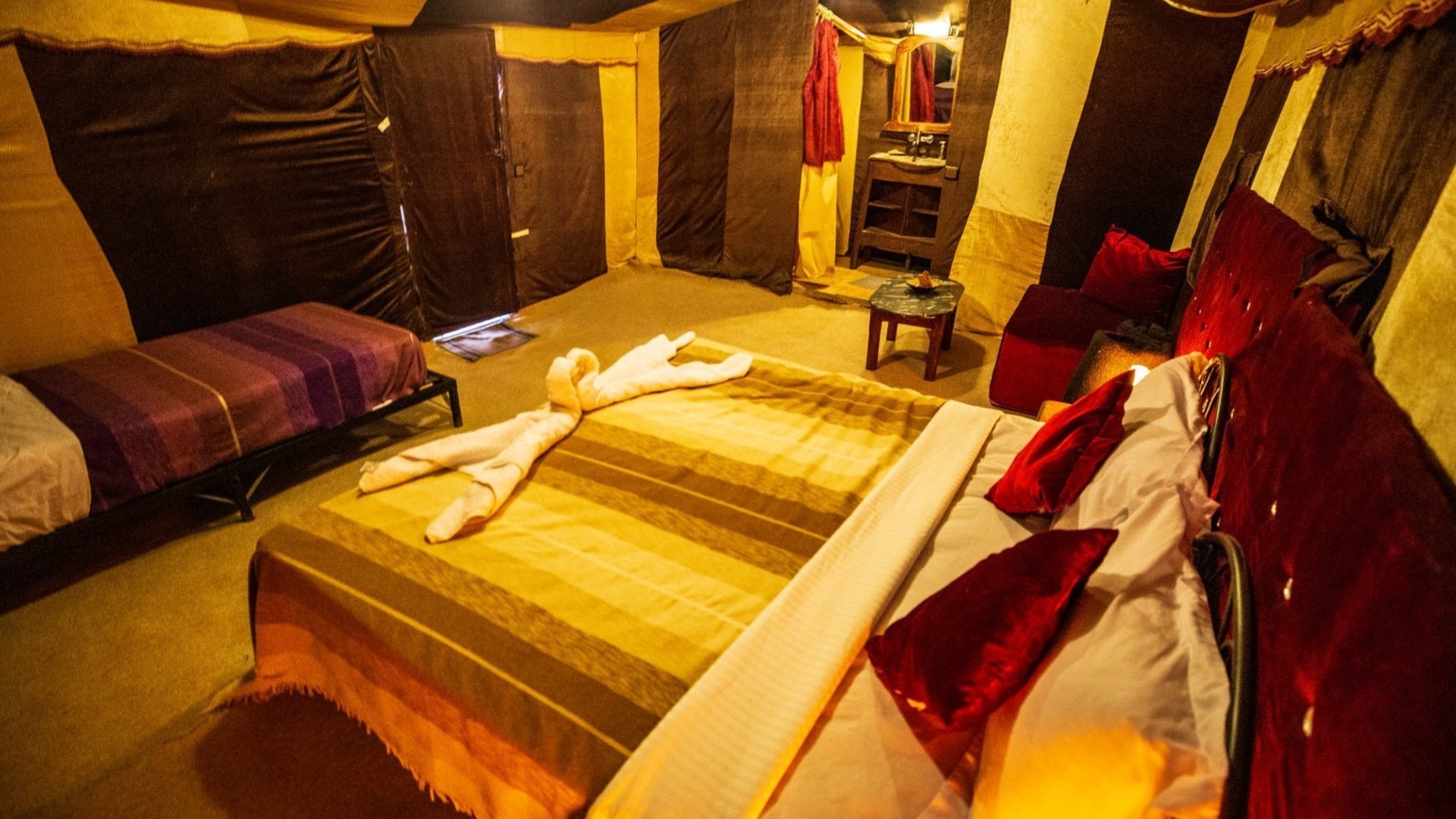 A cozy bed adorned with Moroccan patterns and vibrant textiles in a serene setting