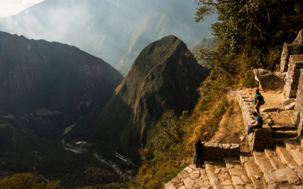 Enjoy the path to Machu Picchu at sunrise, surrounded by panoramic views of lush jungle