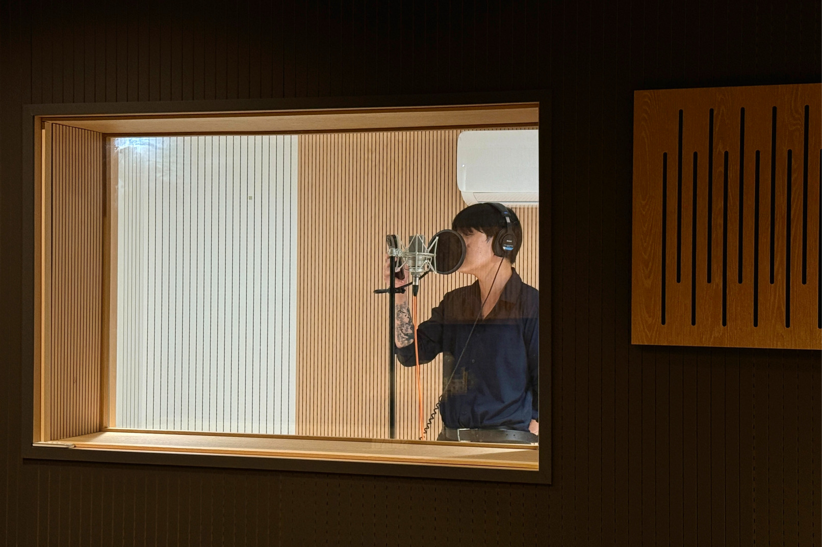 There is a window between the recording booth and the control room for easy communication.