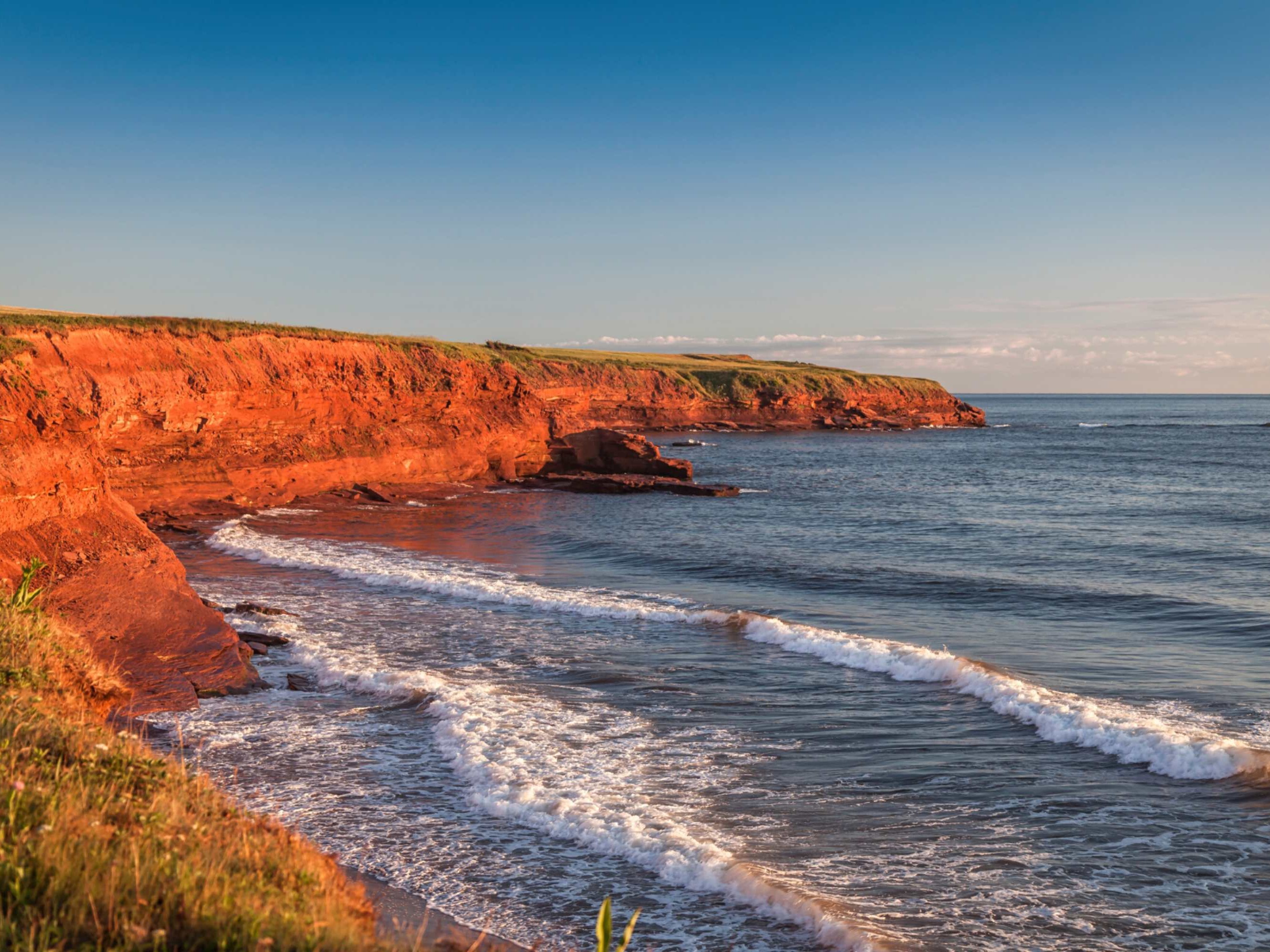 Enjoy a stunning harbor view with sailboats gently drifting against Charlottetown’s historic waterfront backdrop