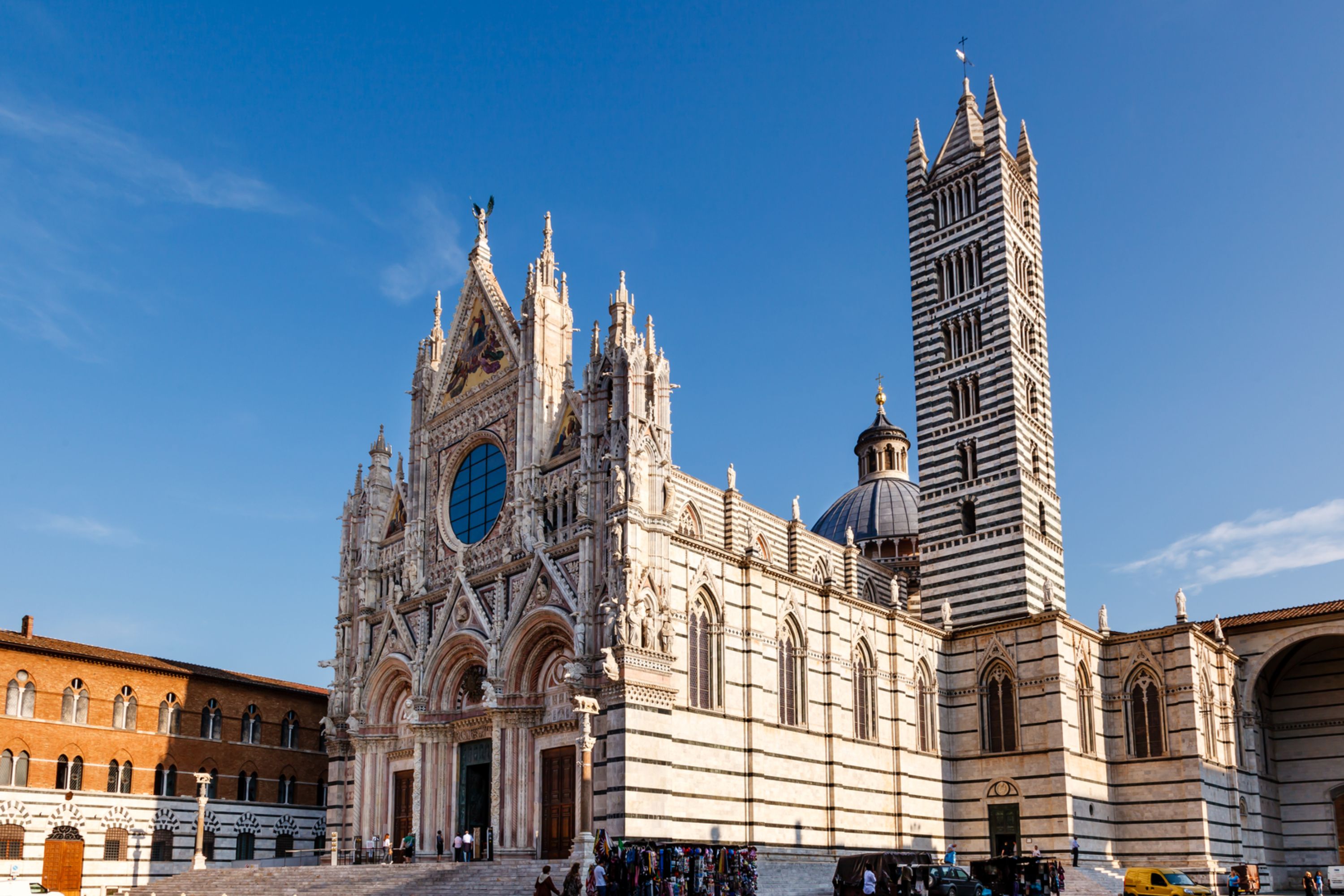 Stroll along Siena's narrow medieval streets, flanked by splendid palaces and historic shops