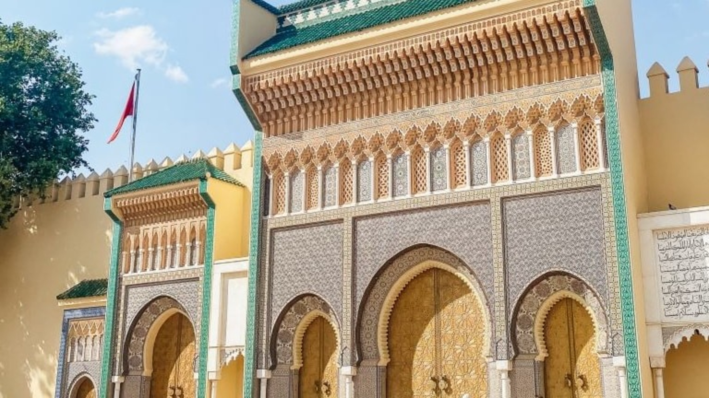 Marvel at the grand Royal Palace gates of Fez, adorned with intricate Moroccan craftsmanship