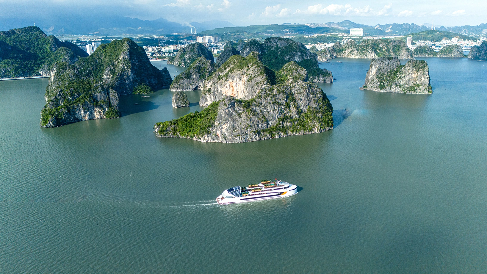 Luxury cruise sailing through emerald waters of Halong Bay
