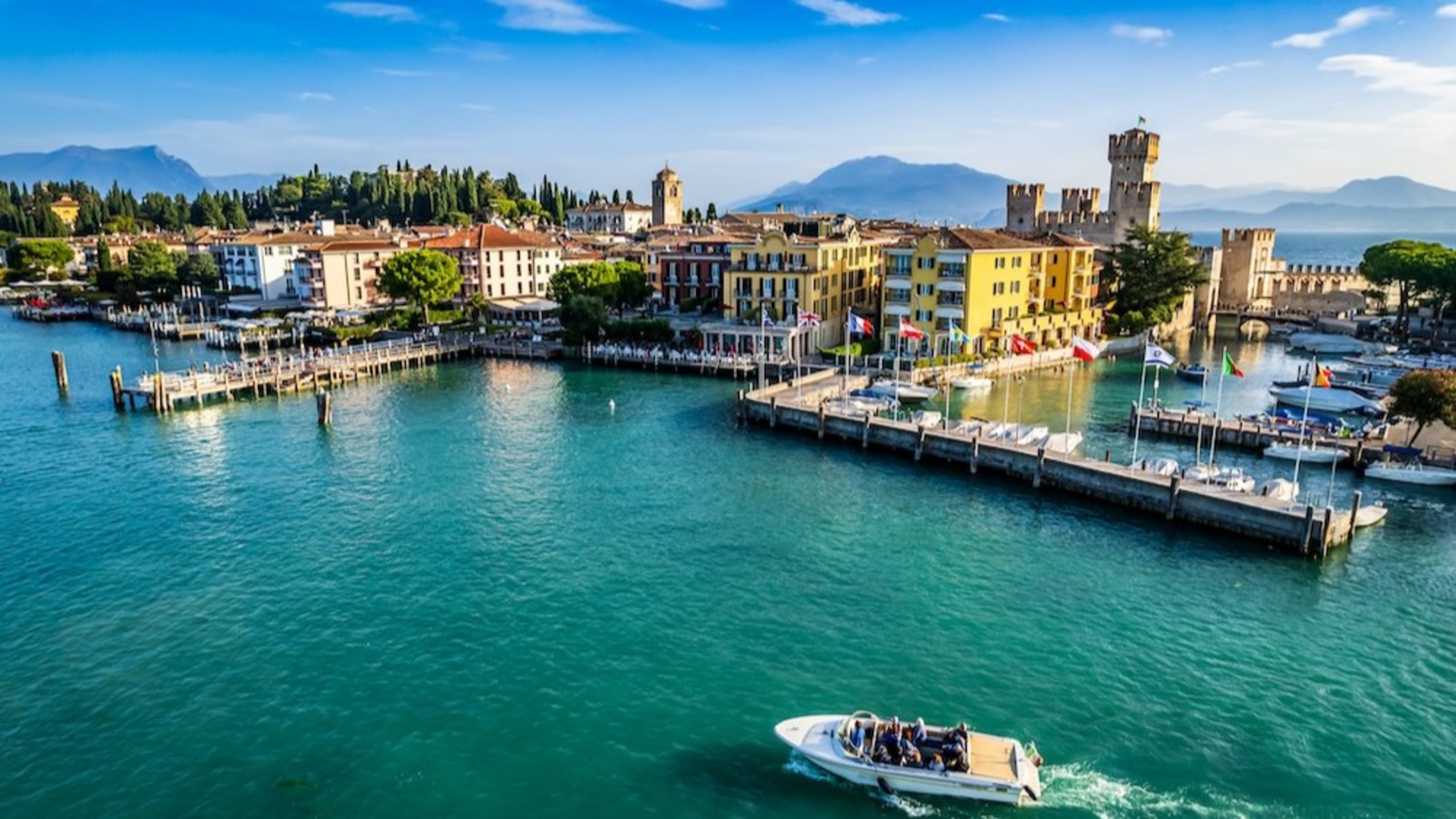 Sirmione's vibrant harbor, Scaliger Castle, and shimmering Lake Garda create the ultimate scenic retreat