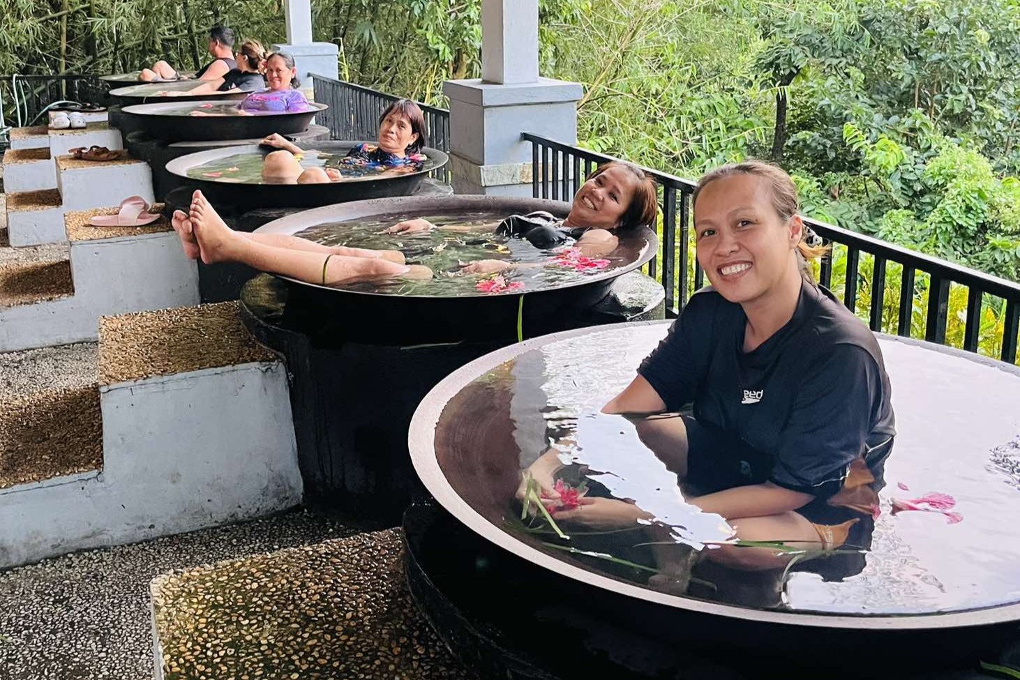 Group enjoying a soak in separate kawa baths