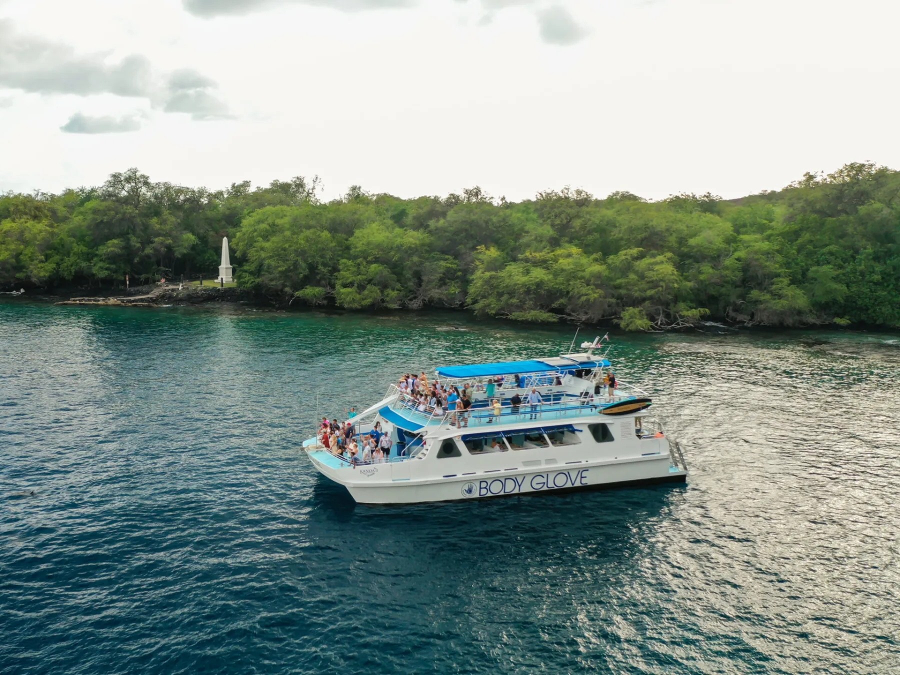 Cruise the stunning Kona Coast aboard a comfortable catamaran, offering optimal views and plenty of shade