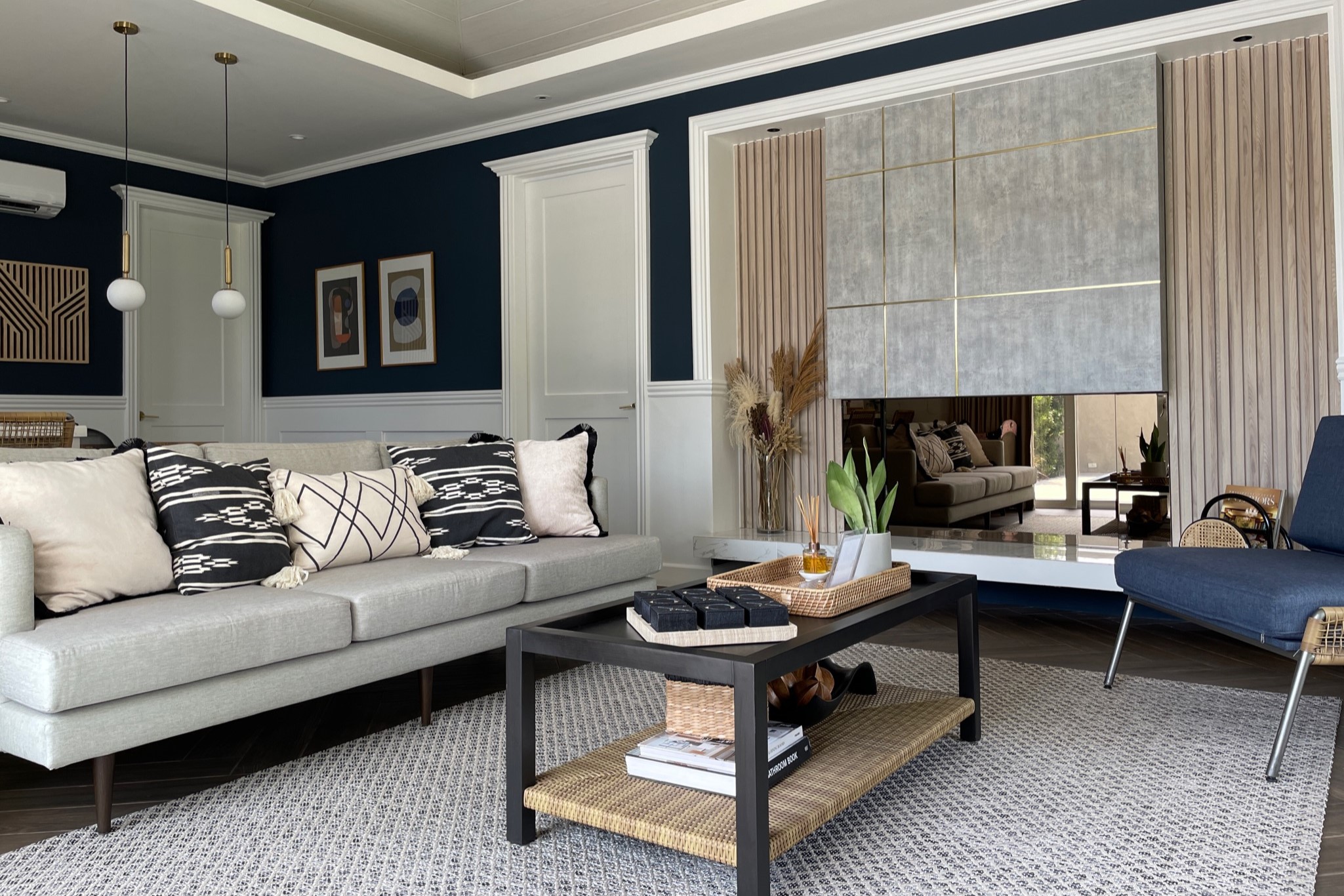 A cozy living room featuring blue walls and white furniture