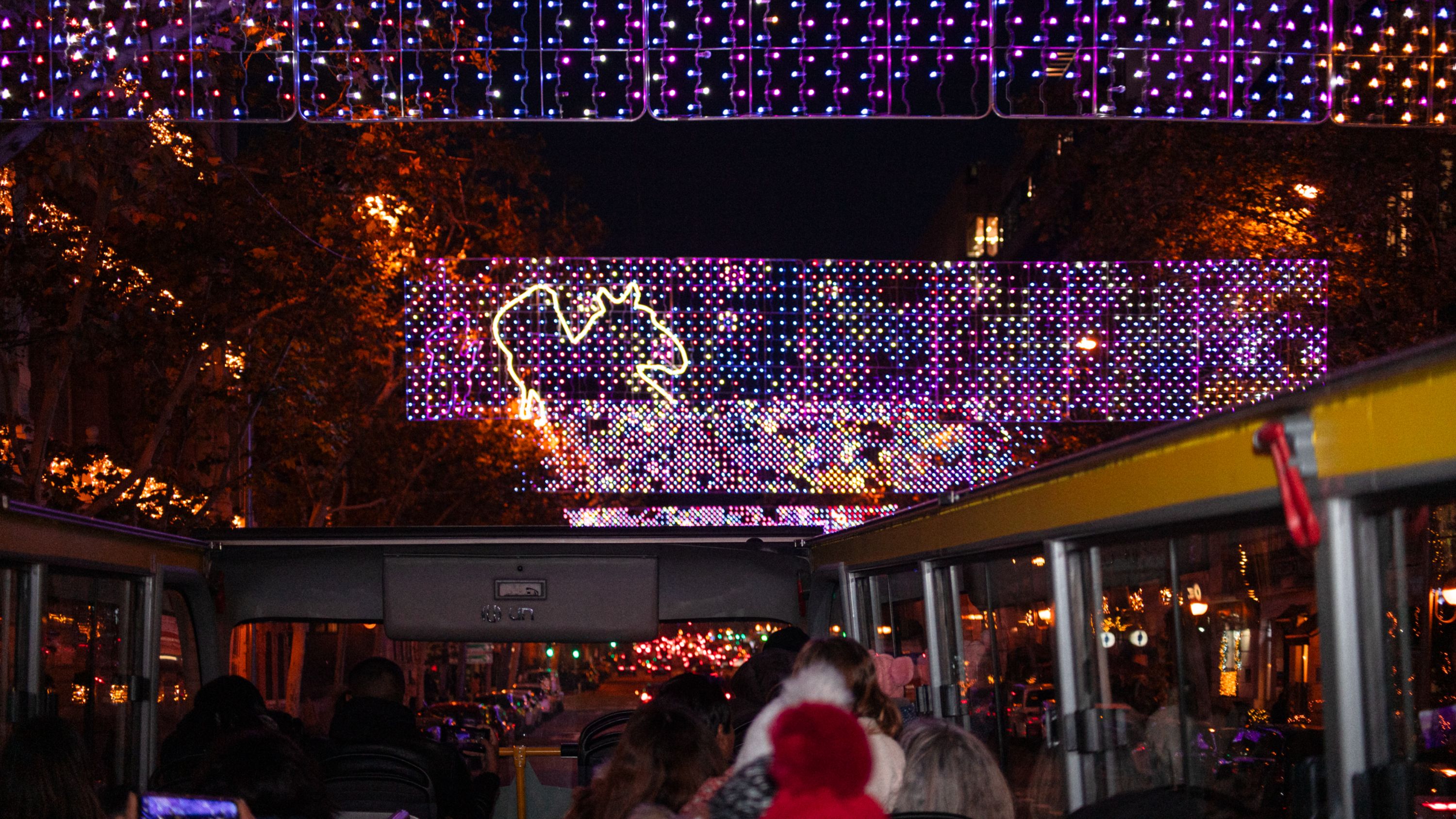 Discover Madrid’s vibrant holiday atmosphere with a fun, festive open-air ride