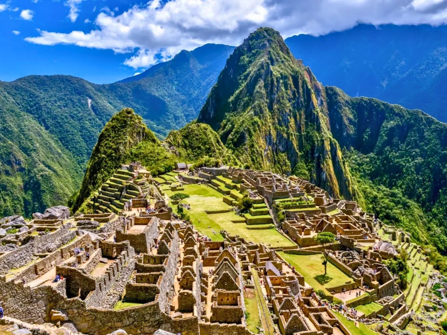 Iconic view of Machu Picchu ruins surrounded by mountains.