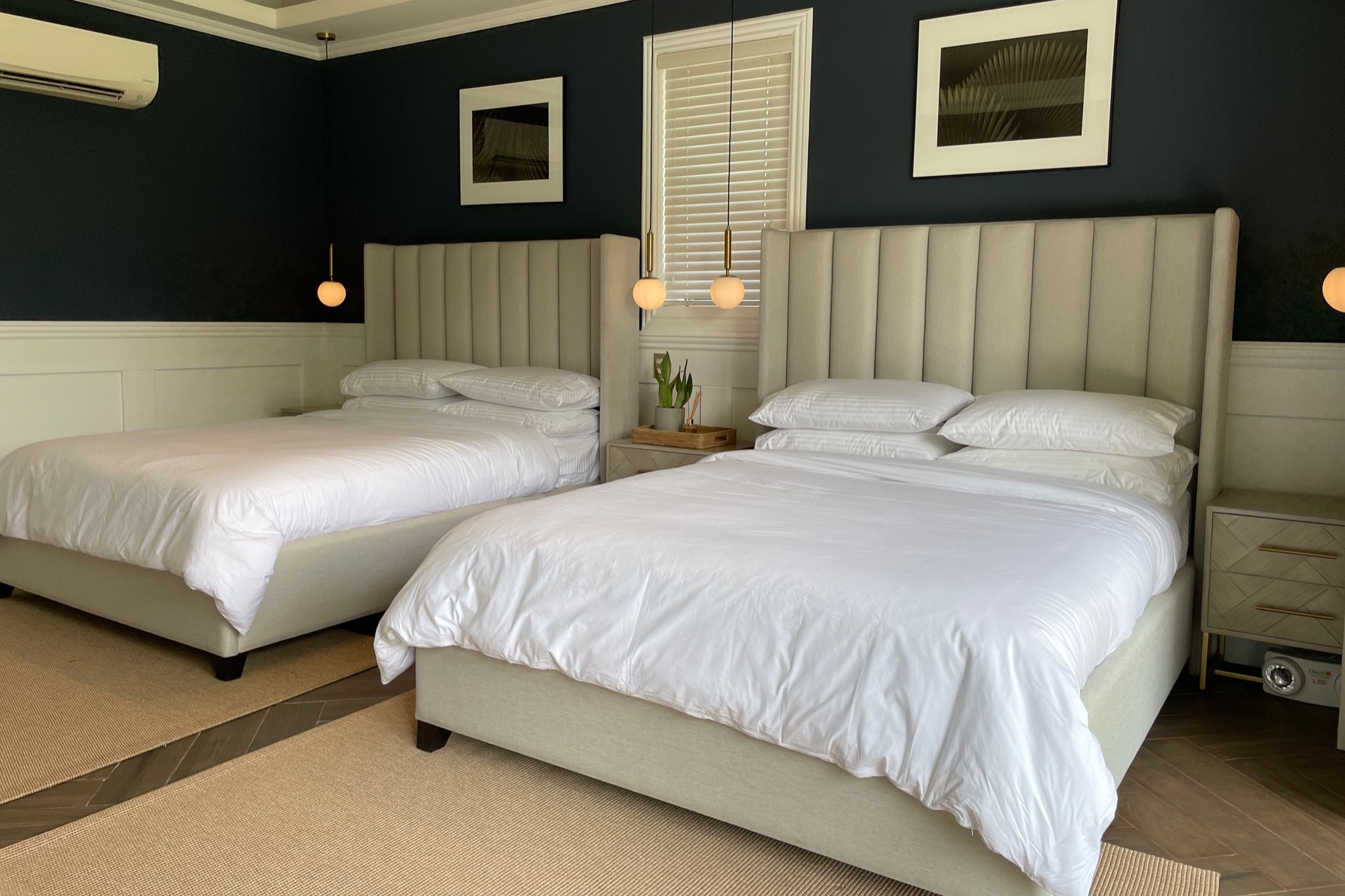 A relaxing bedroom with two beds and blue walls