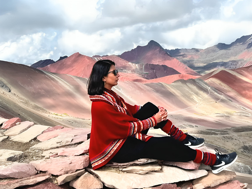 Traveler capturing photos of the breathtaking scenery with a wide-angle camera lens.