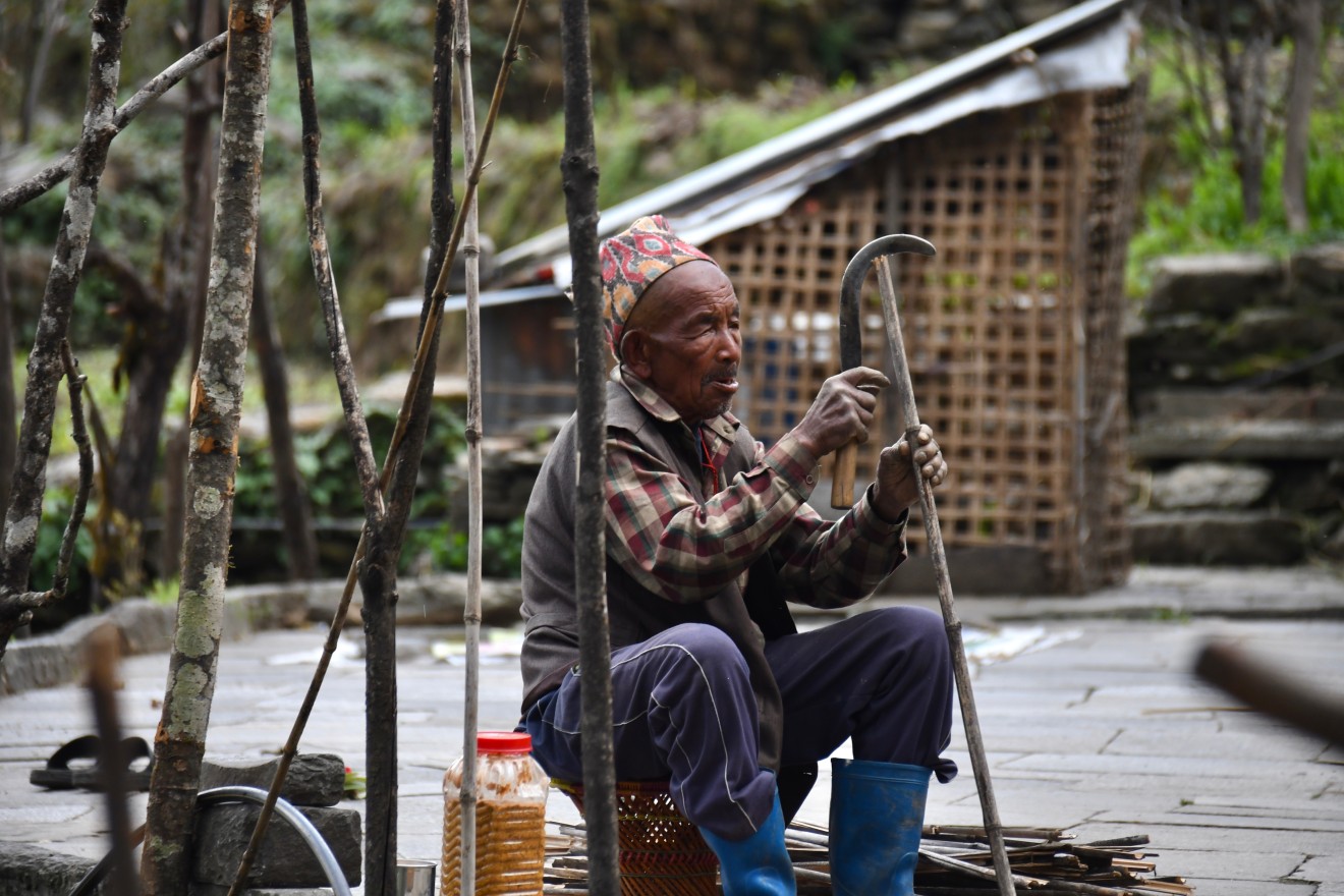 old man is busy to making traditional daily products using bamboo