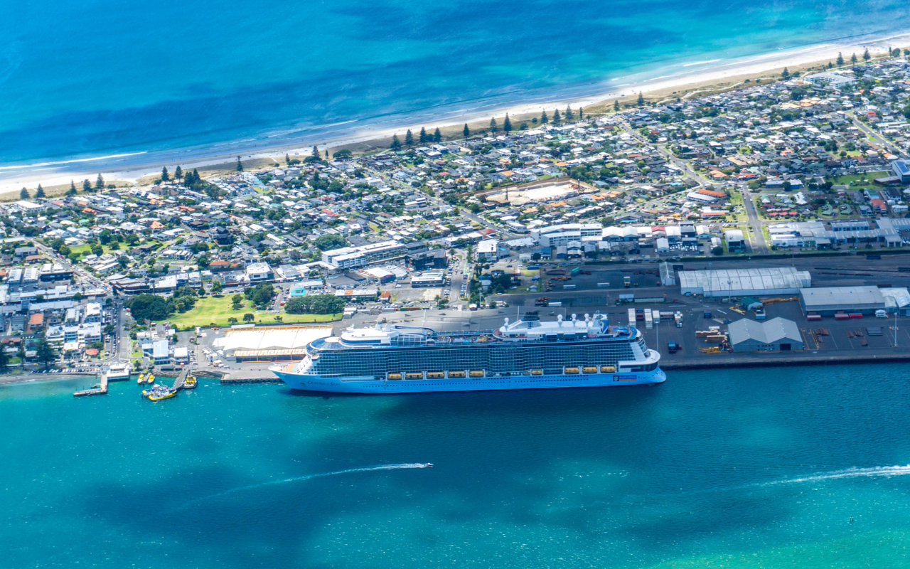 Fly above Mount Maunganui’s stunning beaches and passing cruise ships