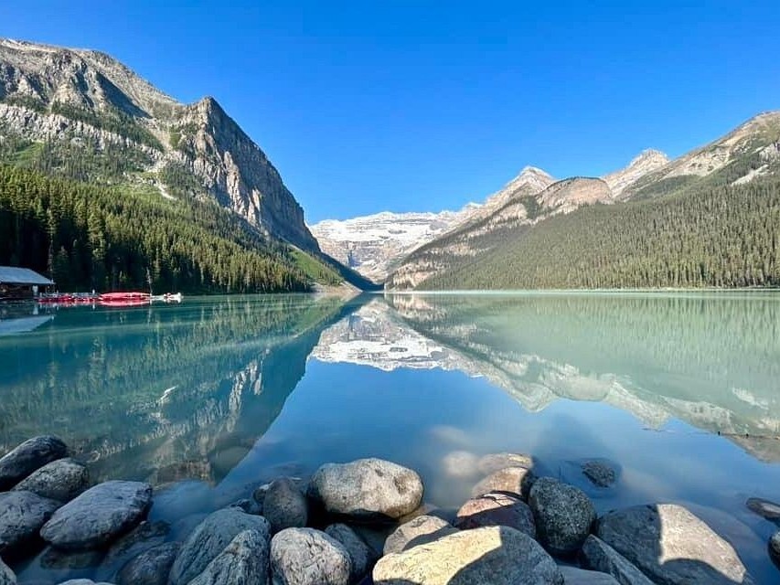 Peaceful morning mist drifting across calm surface of Two Jack Lake