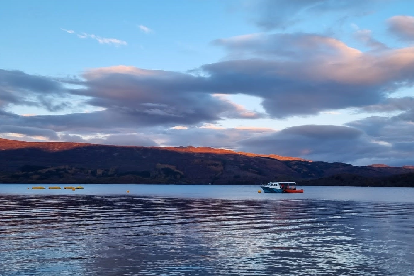 Enjoy a breathtaking Loch Lomond sunset, with vibrant colors reflecting on serene waters