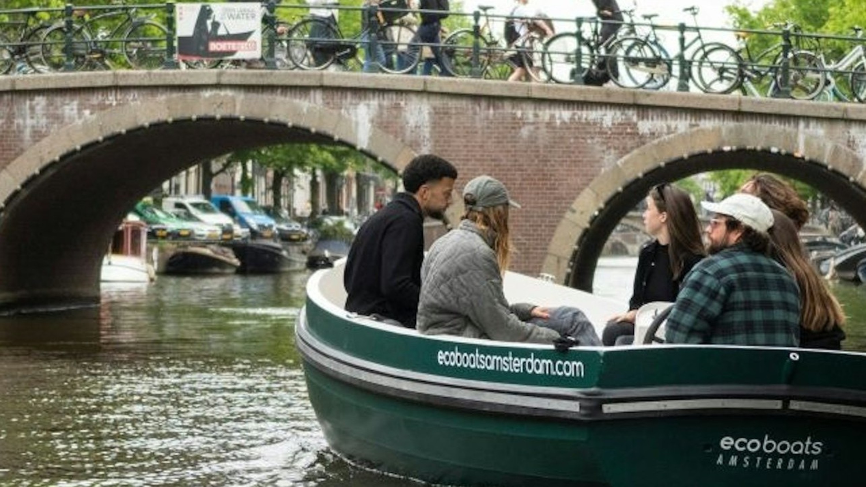 Glide through sunlit canals with your friends as Amsterdam’s charm unfolds one bridge at a time