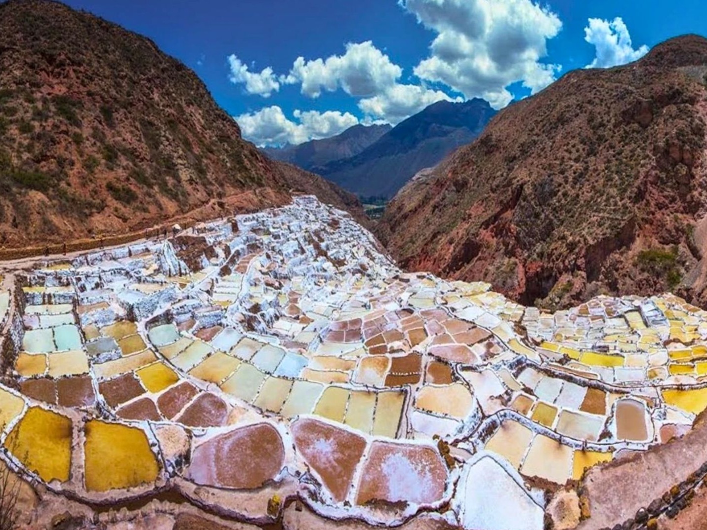 Witness the dazzling salt pools of Salineras, glistening like snow under the sun.
