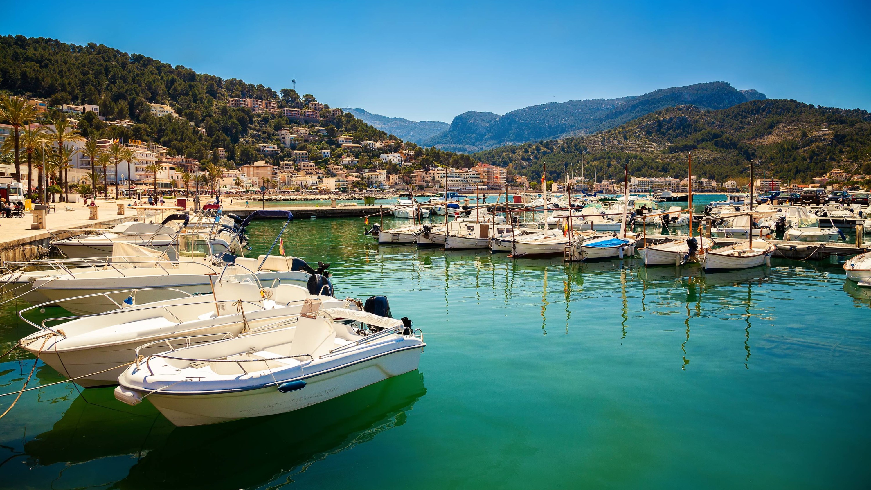 Fishing boats and yachts bobbing gently in the calm waters of Port of Soller