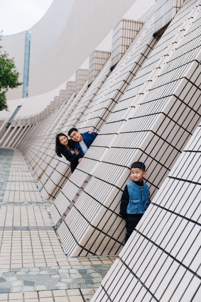 A fun family photo framed by the unique design of the cultural center, highlighting the artistic spirit of the city.