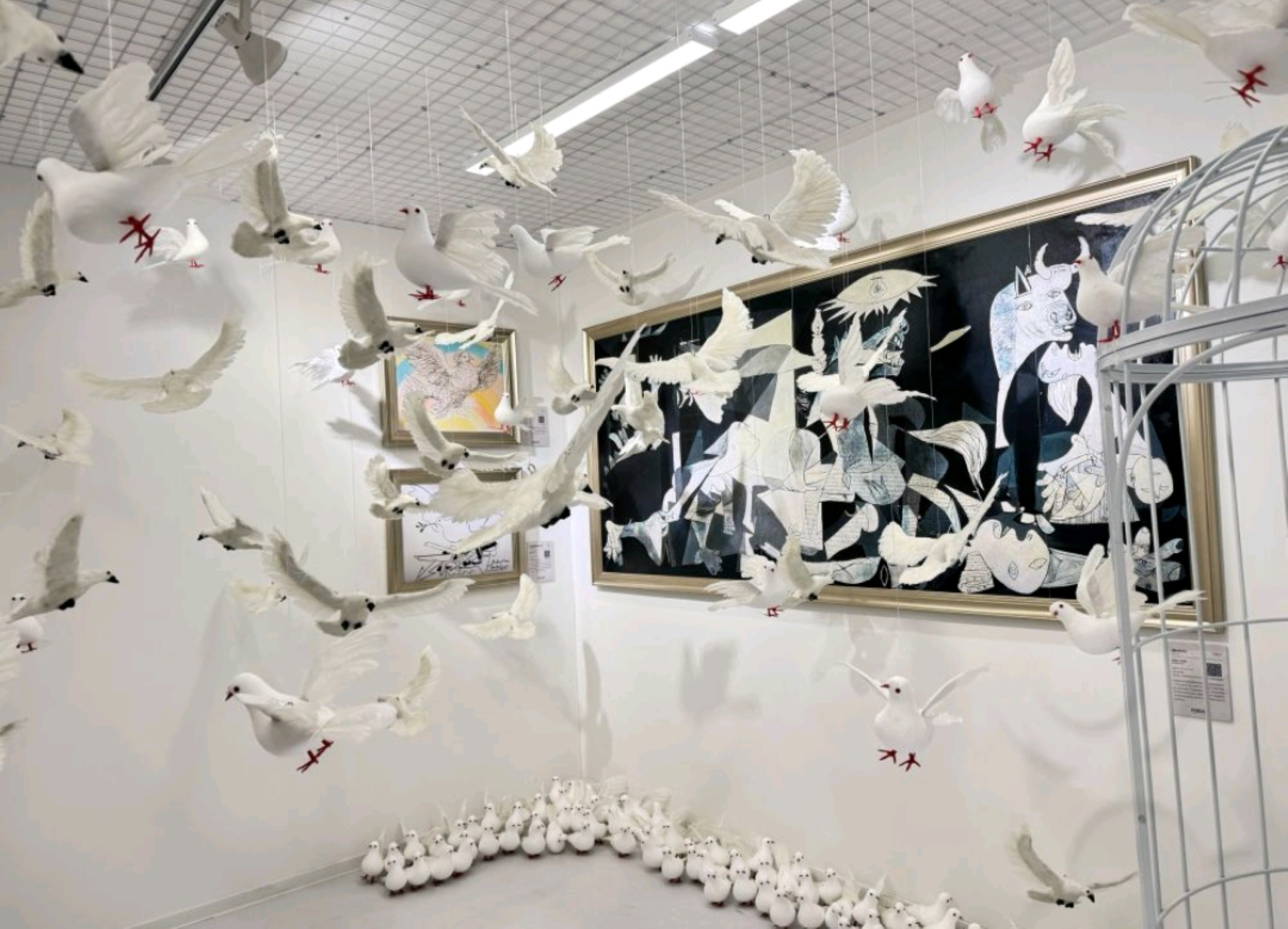 上百隻仿真白鴿被懸掛在空間中,營造出群鴿飛舞的沉浸式視覺效果 上百隻仿真白鴿被懸掛在空間中,營造出群鴿飛舞的沉浸式視覺效果