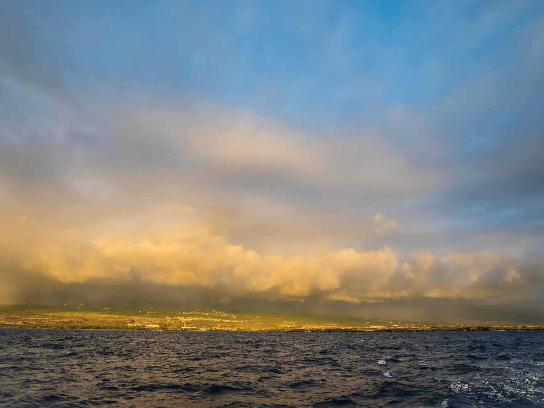Admiring sunrise where fiery orange sky meets deep blue sea