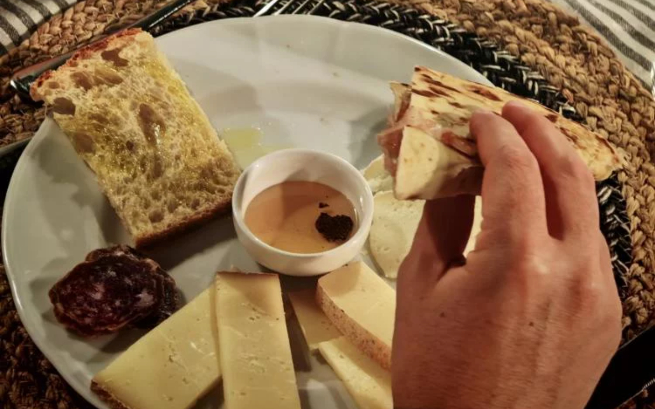 Share a convivial evening over a spread of artisanal cheeses, honey, and regional specialties