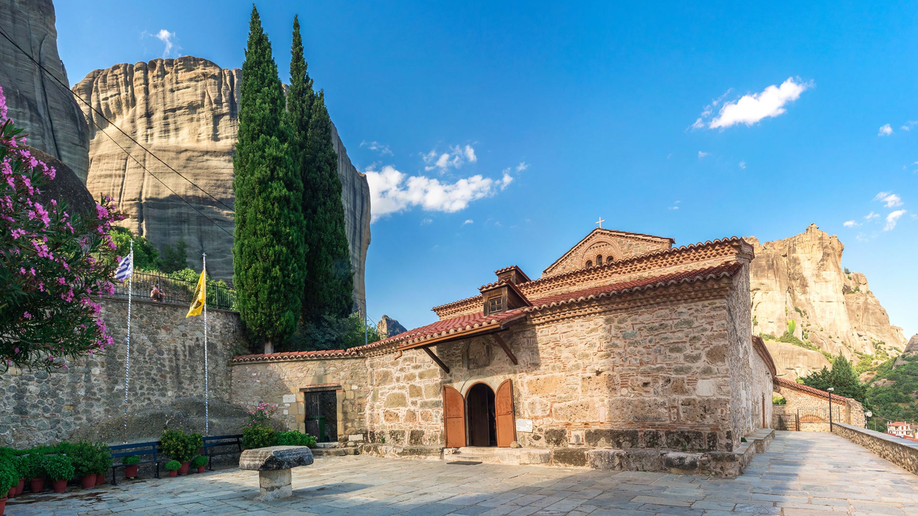 Step inside a centuries-old monastery, surrounded by Meteora's majestic rock formations and serene landscapes