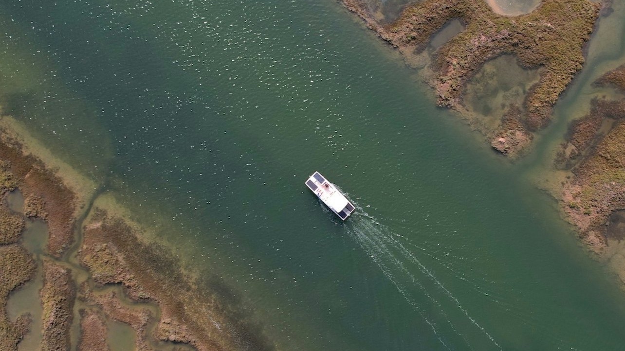 Capture the breathtaking views of sun-kissed lagoons while sailing sustainably through nature