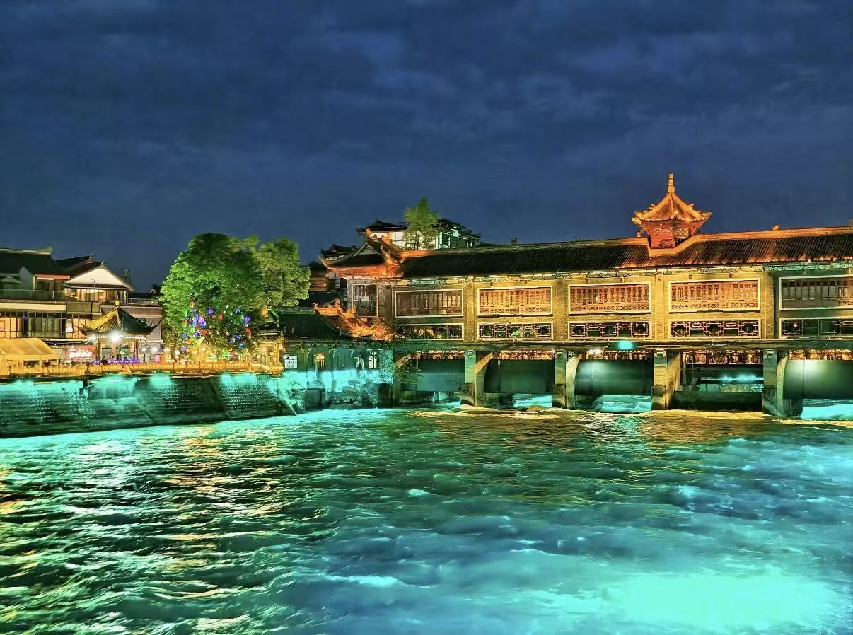 都江堰南橋夜景璀璨,廊橋燈火勾勒出精緻的中式輪廓,江水被燈光染成青綠,水流奔湧,古橋與波光交映,盡顯夜堰的浪漫氛圍感 都江堰南橋夜景璀璨,廊橋燈火勾勒出精緻的中式輪廓,江水被燈光染成青綠,水流奔湧,古橋與波光交映,盡顯夜堰的浪漫氛圍感