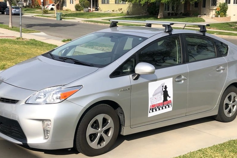 The tour will be conducted in a Silver Prius featuring the Movie Guys logo, ensuring a comfortable ride