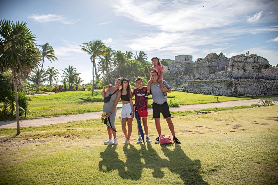 Guests capturing photos of the breathtaking views at the Tulum archaeological site