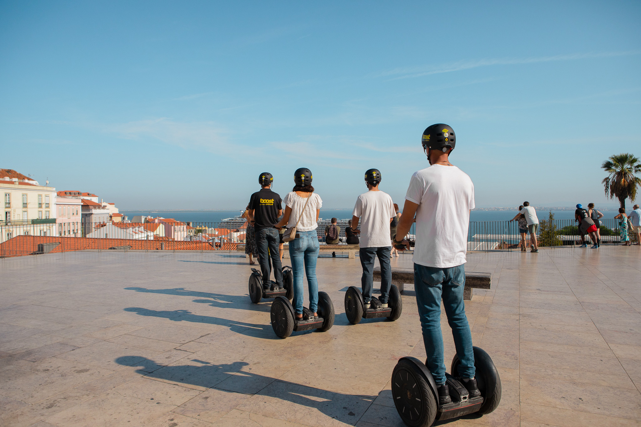 Segway Lisbon Guided Tour in Lisbon. Tourists heading to Portas do Sol viewpoint to gaze into the Tagus River.