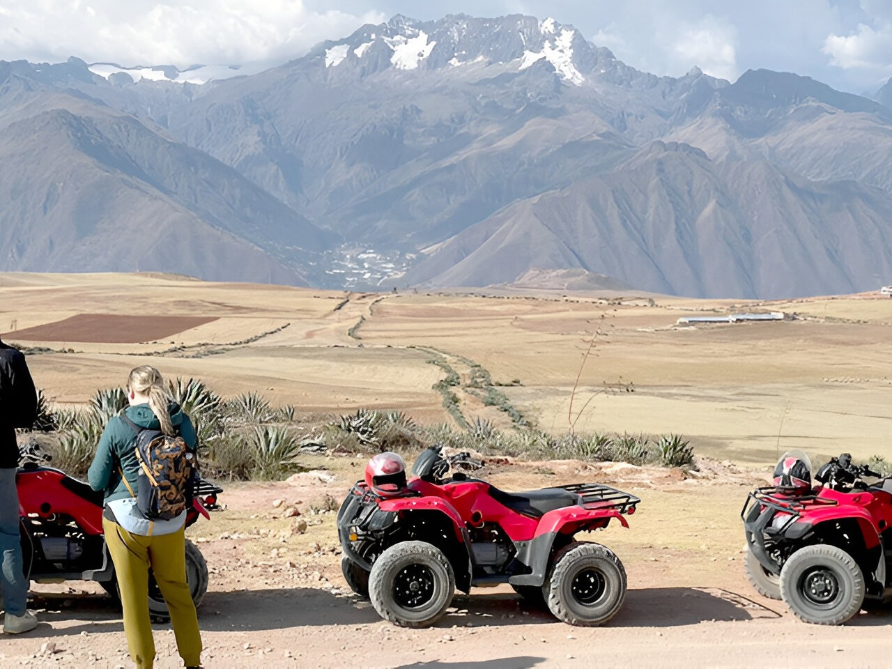 Winding dirt road leading to ancient Incan sites surrounded by rolling green hills