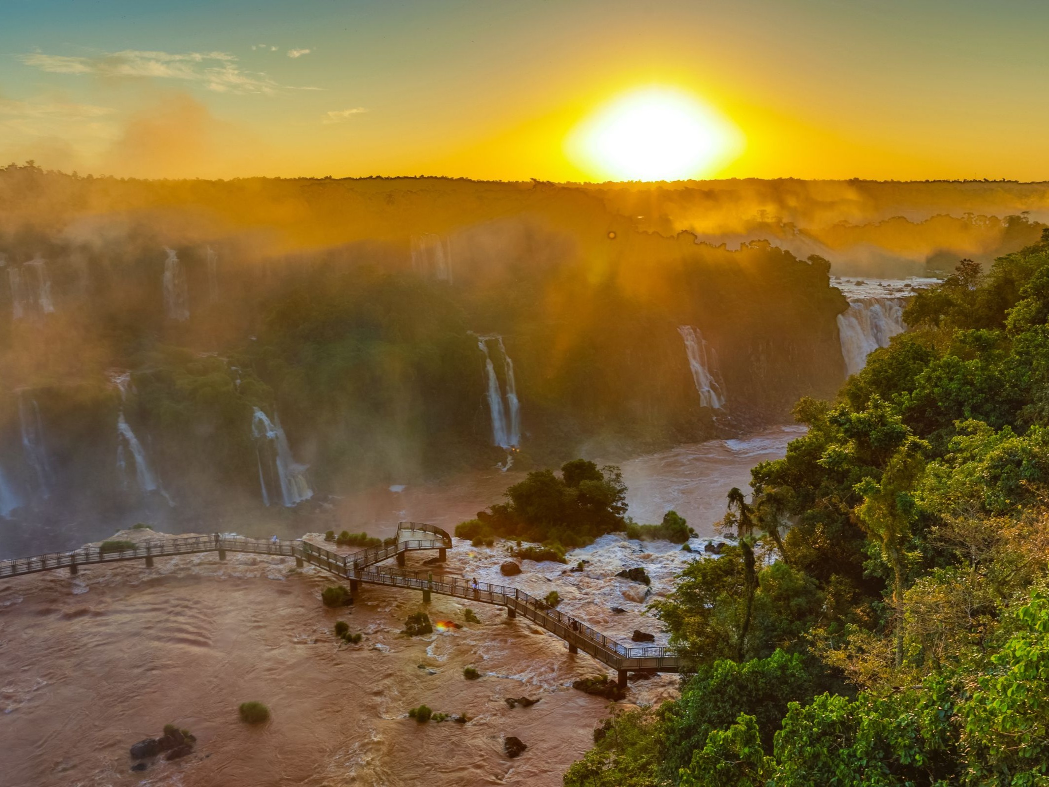 Nature says goodbye with a golden show. Experience an unforgettable sunset at the Brazilian side of Iguazu Falls.
