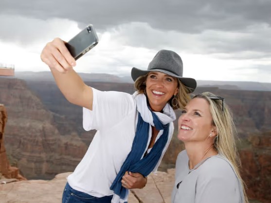 Visitors stepping onto the breathtaking Grand Canyon Skywalk, suspended high above the canyon floor