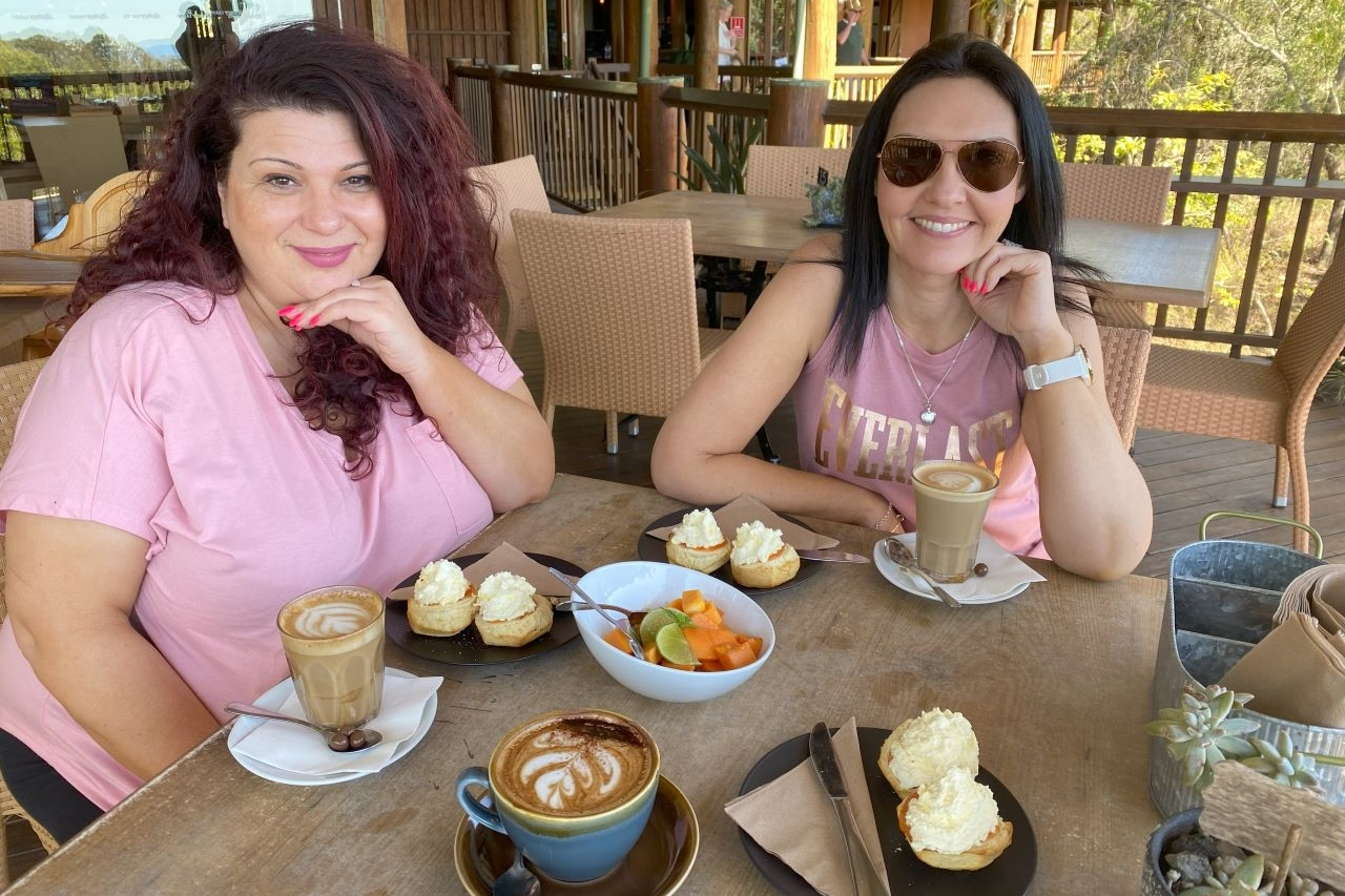 Savor freshly brewed Skybury coffee with scones, papaya jam, and ripe papaya slices