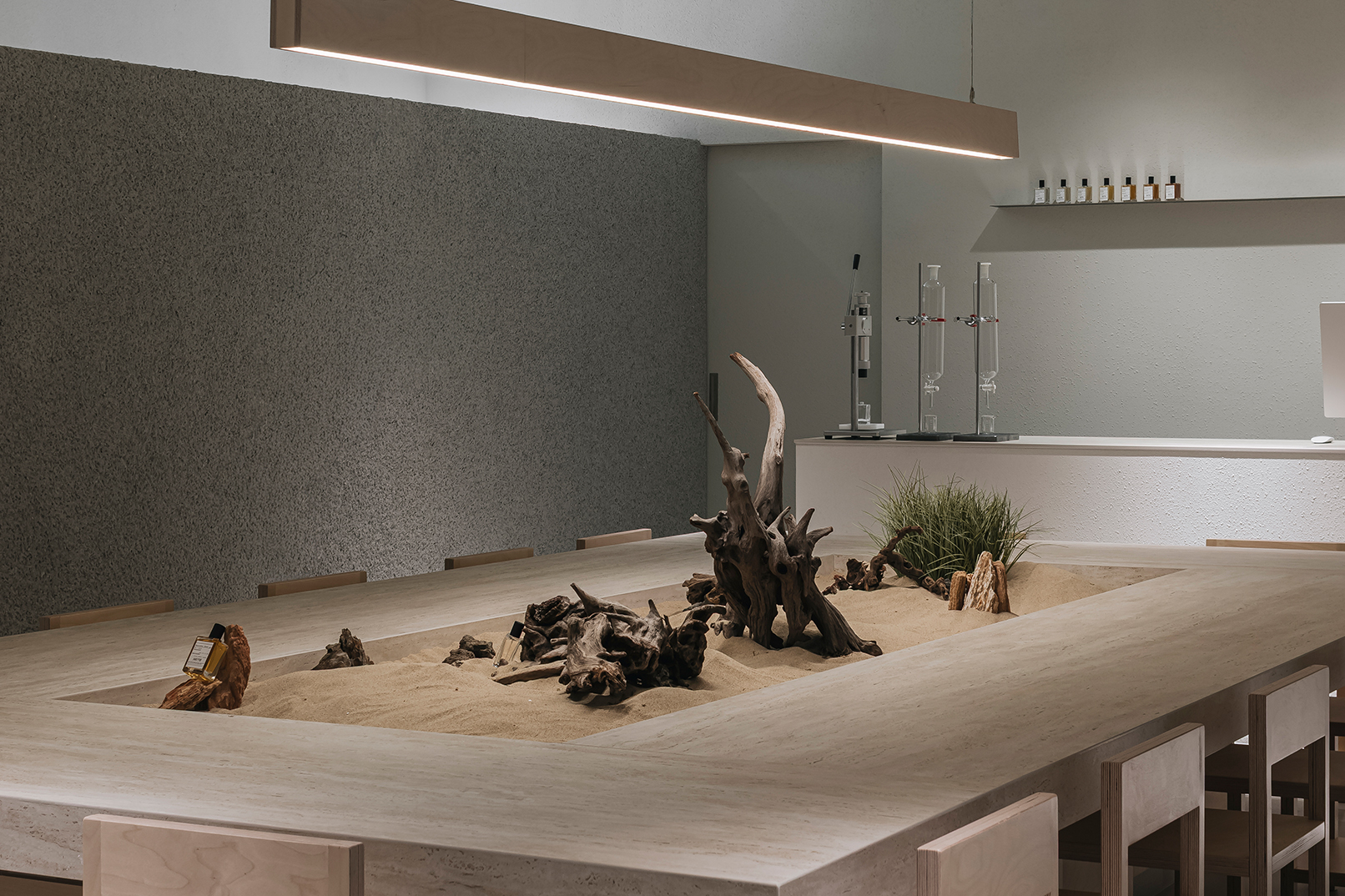 (Creation & Photography Space) This is where you blend your chosen scents to create a one-of-a-kind perfume, uniquely yours. Your completed fragrance is then captured as your first masterpiece in the stunning central garden space.