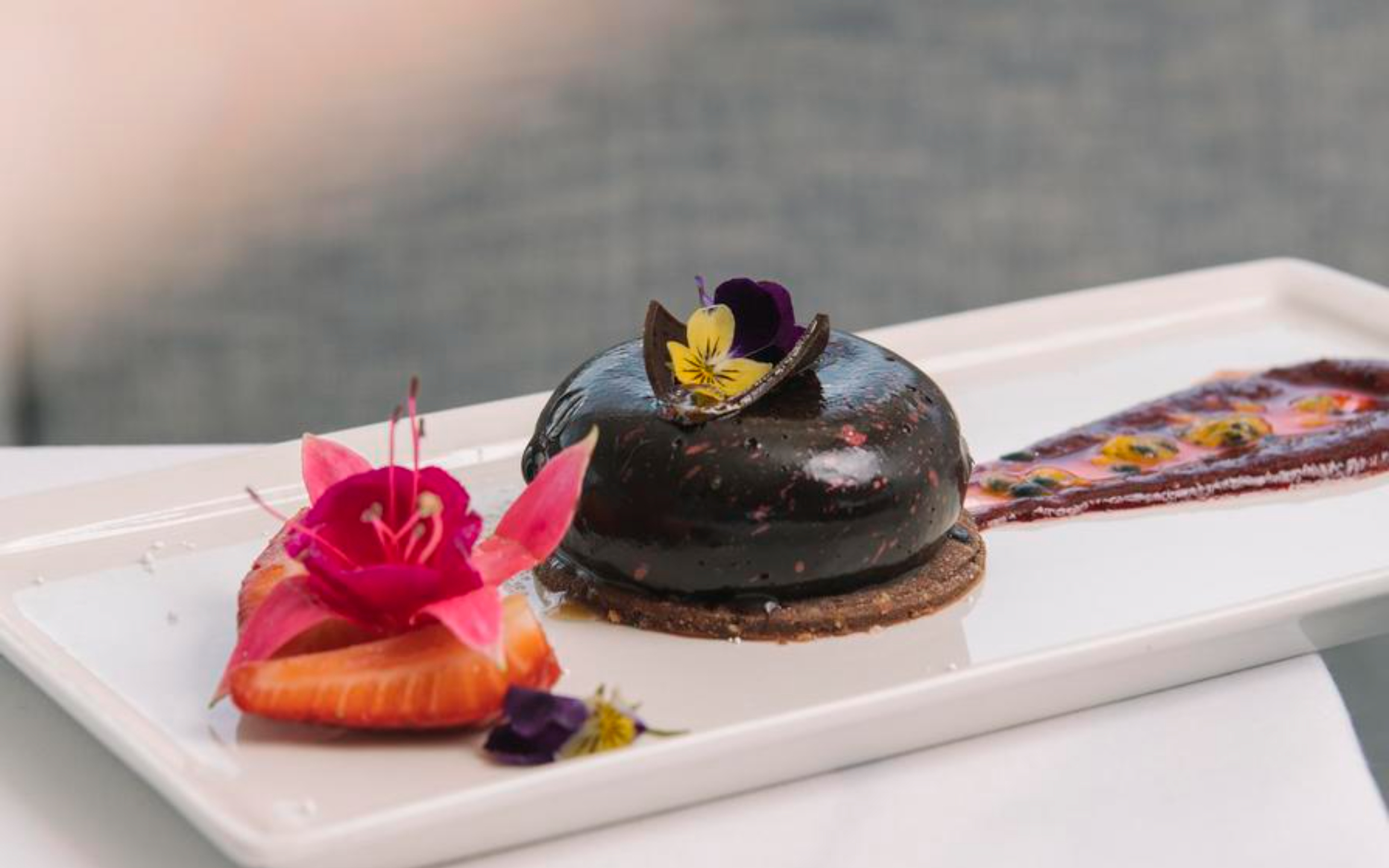 Elegant dessert beautifully plated, delicate garnishes, and soft lighting enhancing the indulgent onboard dining experience