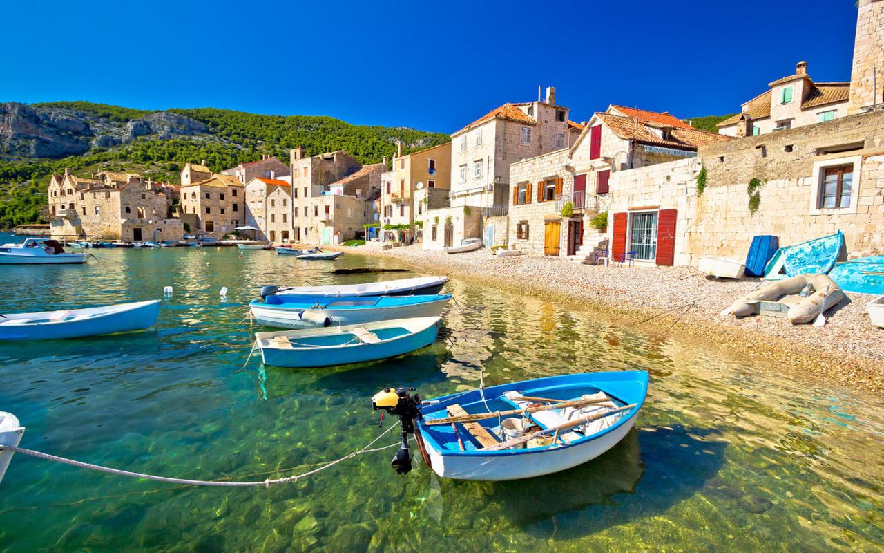 Discover a charming coastal village with colorful boats and peaceful harbor views