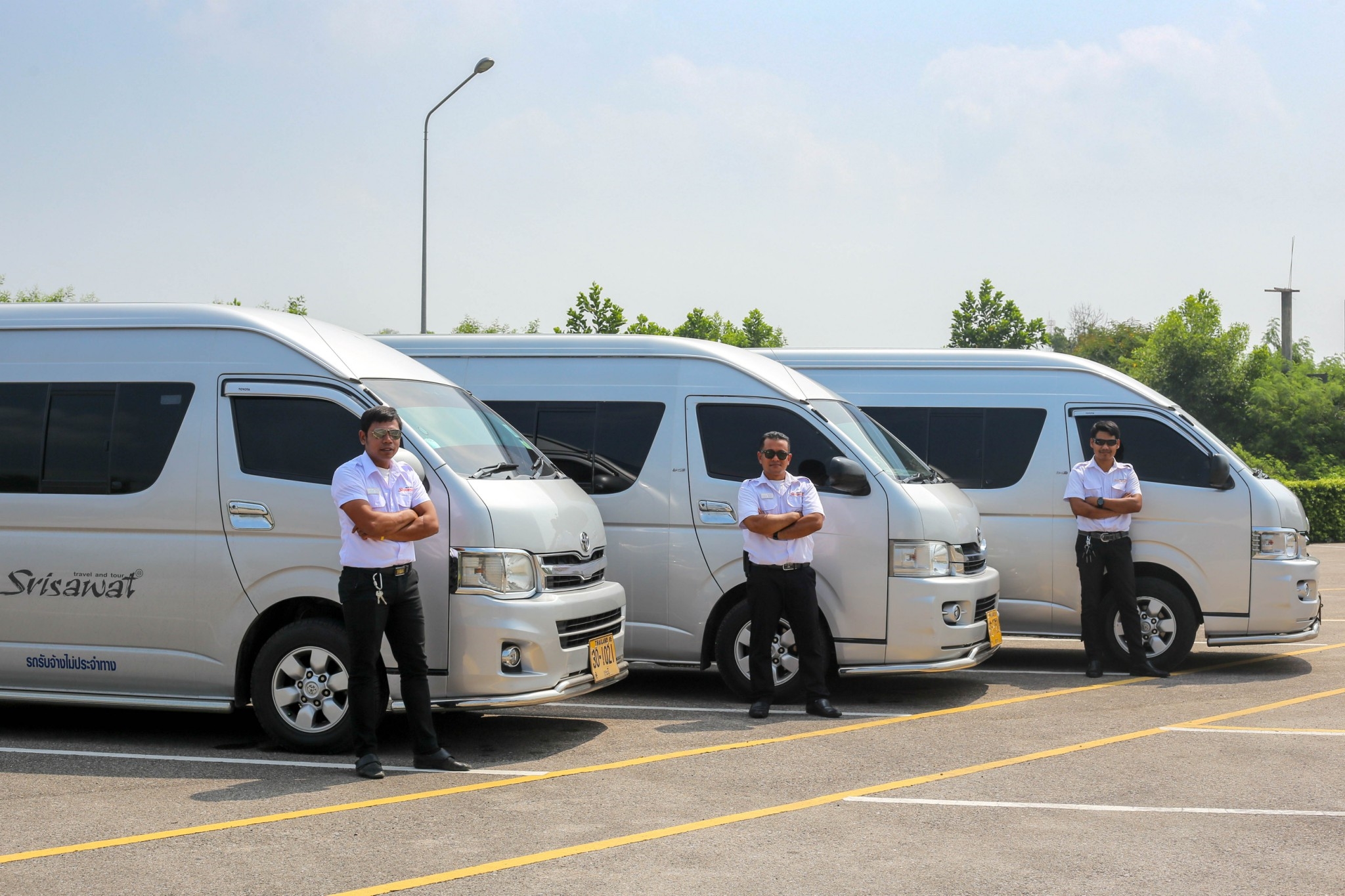 tourists standing in front of van