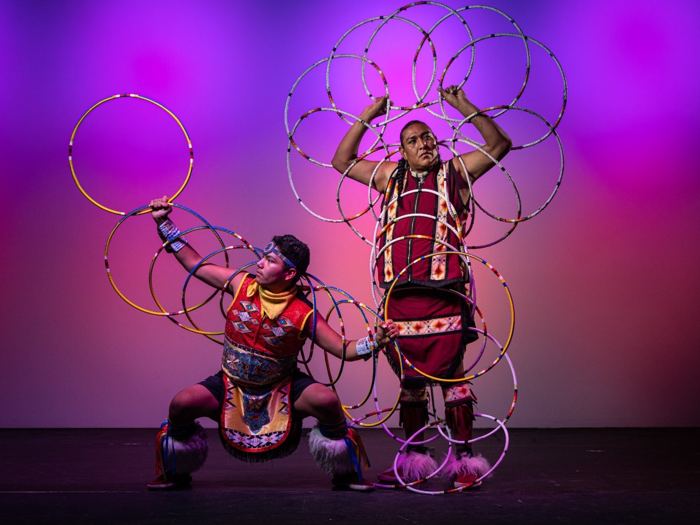 Perform Native American Hoop Dance, skillfully manipulating hoops into animal shapes and flowing patterns