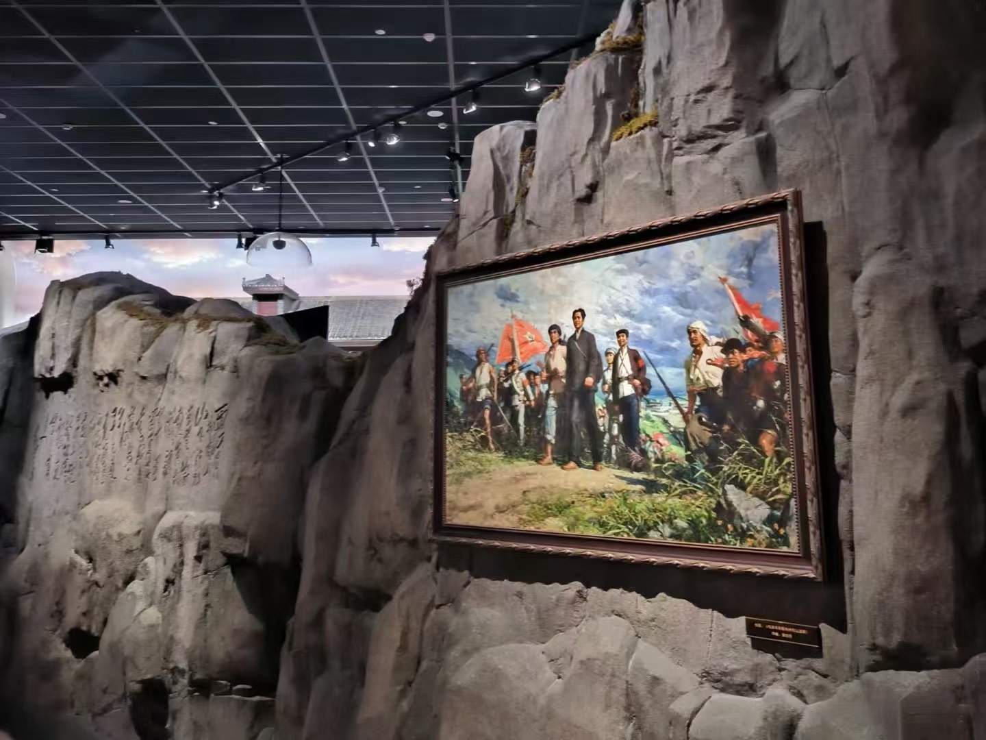 紀念館內以仿真巖壁為展陳背景,懸掛著描繪革命場景的油畫,光影營造出山林氛圍,生動還原歷史瞬間,讓參觀者沉浸式感受紅色記憶 紀念館內以仿真巖壁為展陳背景,懸掛著描繪革命場景的油畫,光影營造出山林氛圍,生動還原歷史瞬間,讓參觀者沉浸式感受紅色記憶
